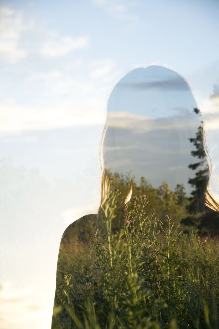 Silhouette of a woman merging with the natural landscape